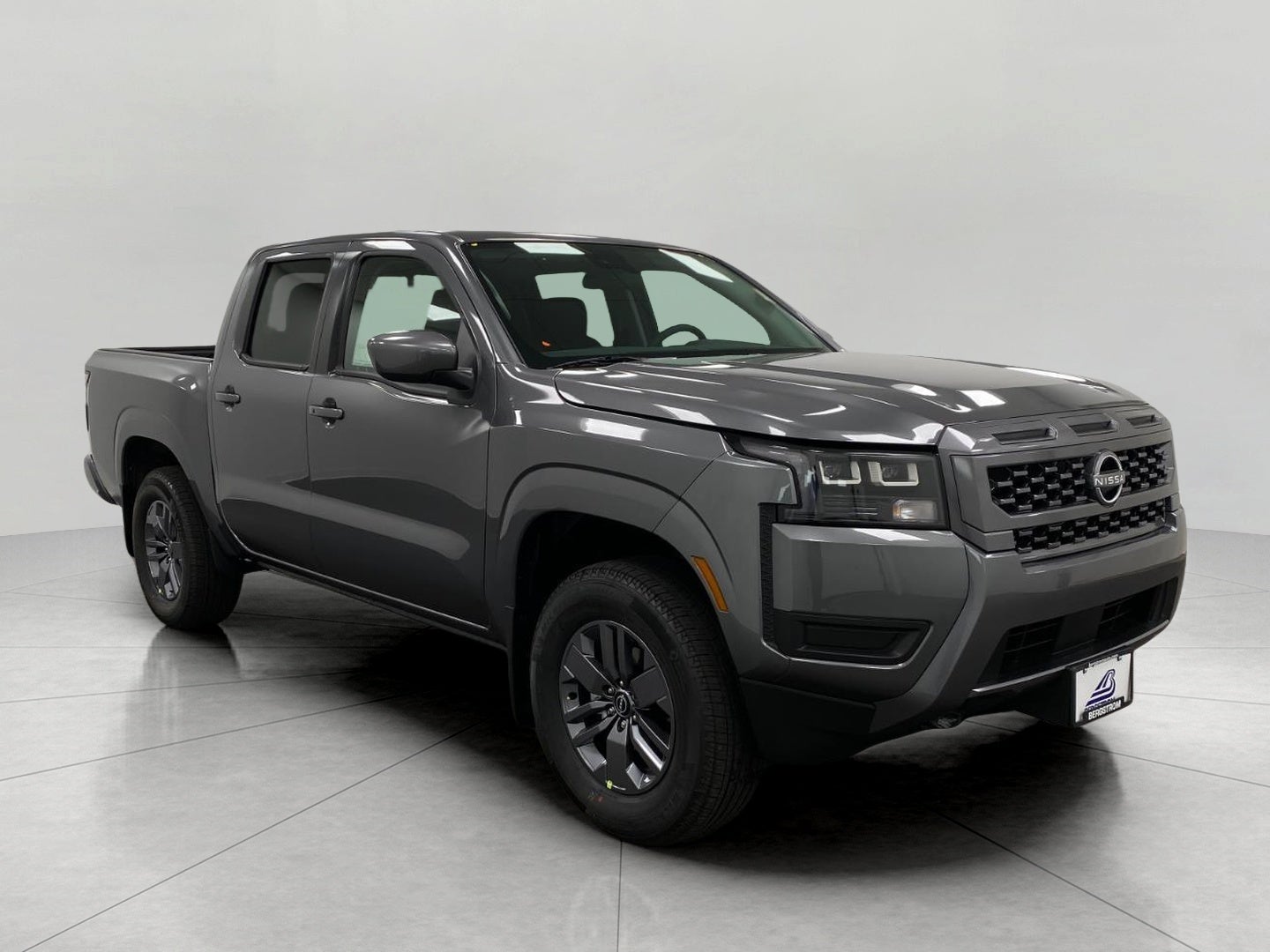 2026 Nissan Frontier Crew Cab SV in Gun Metallic — front three-quarter view