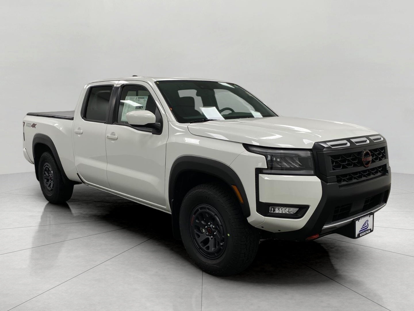 2026 Nissan Frontier Crew Cab PRO-4X Long Bed in Glacier White — front three-quarter view
